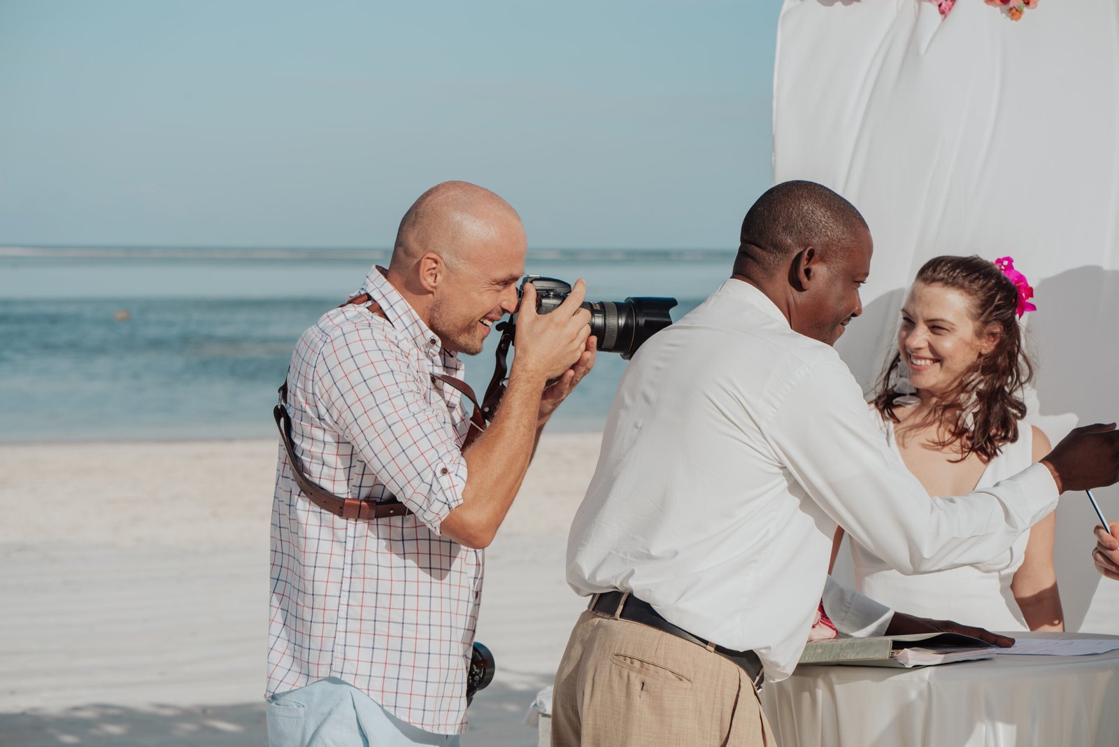 Luxury wedding photographer Michal Dzikowski photographing a destination wedding on a beach in Zanzibar